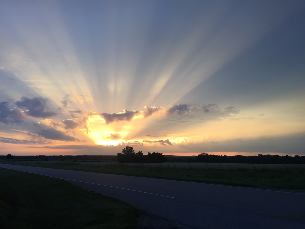 Sunset over rural road and fields